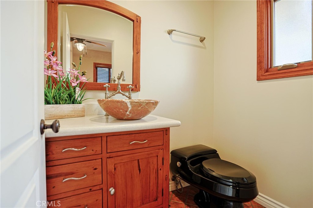 116 Termino Avenue Long Beach, CA 90803 - Photo 10 of 51 a bathroom with a granite countertop sink a toilet and mirror