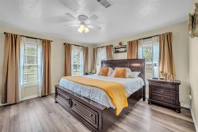 a bedroom with a bed and a chandelier