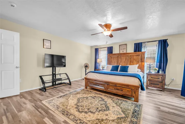 a bedroom with a bed and a chandelier