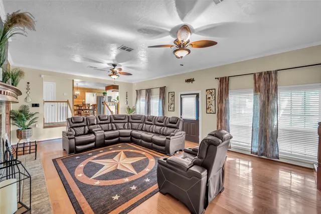 a living room with furniture and a chandelier