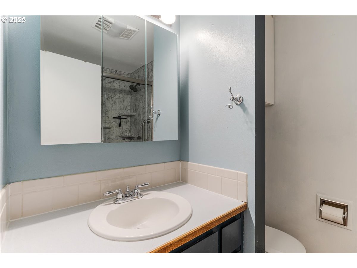 719 South Chehalem Street Newberg, OR 97132 - Photo 13 of 27 a bathroom with a sink and a mirror