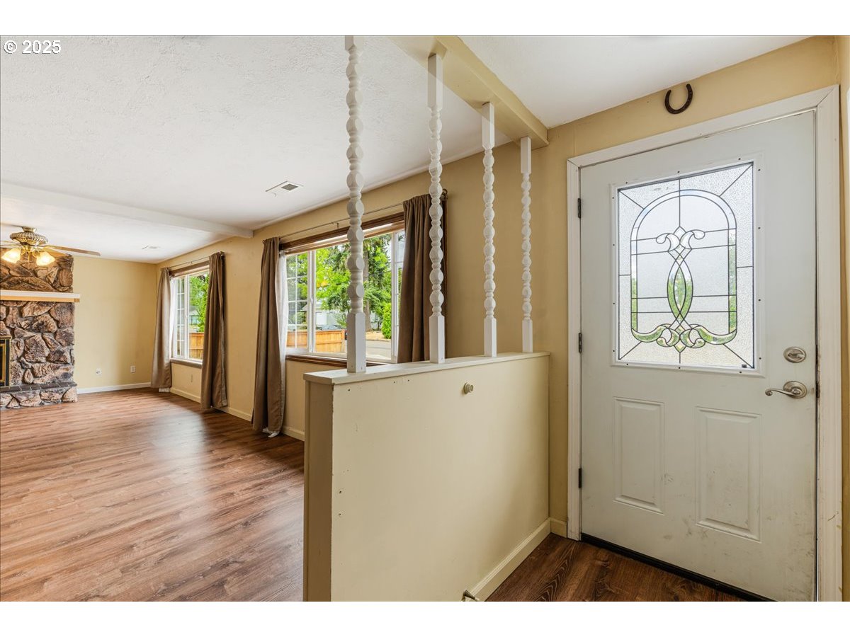 719 South Chehalem Street Newberg, OR 97132 - Photo 4 of 27 a view of an empty room with wooden floor and a window