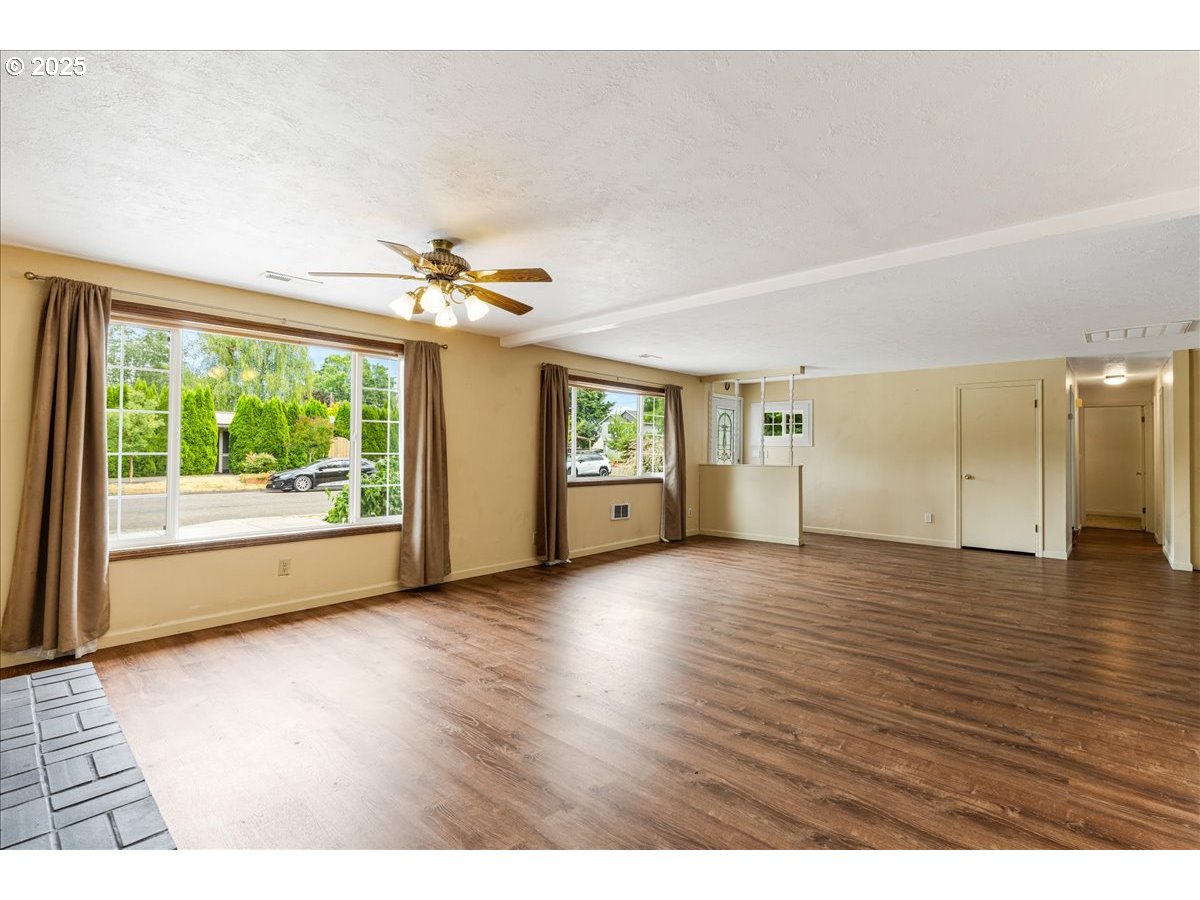 719 South Chehalem Street Newberg, OR 97132 - Photo 5 of 27 a view of an empty room with a window and wooden floor