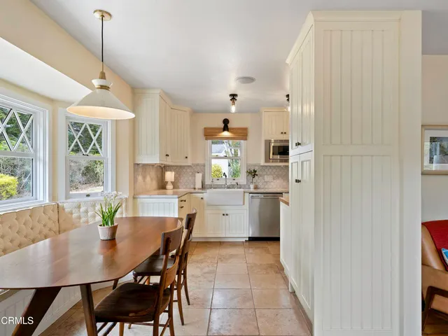 a view of a dining room and livingroom with furniture window and wooden floor