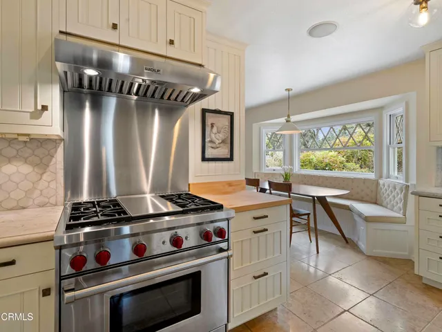 a kitchen with granite countertop a stove and a sink