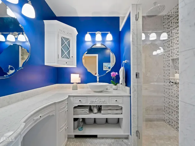 a bathroom with a sink mirror and vanity