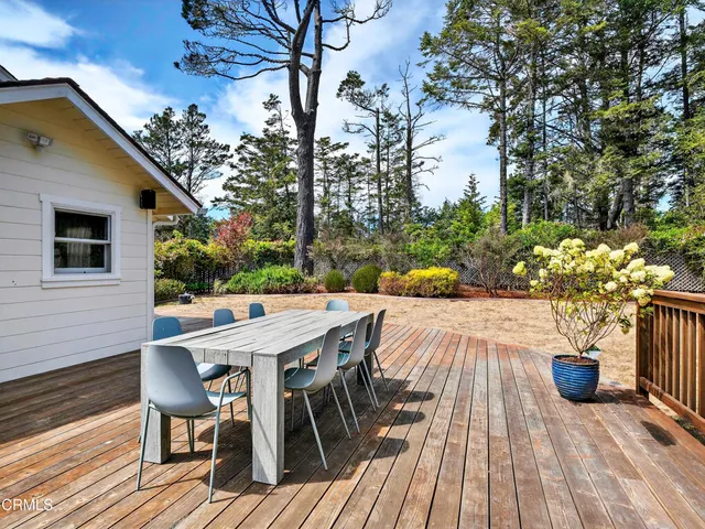 a view of a patio with table and chairs and potted plants