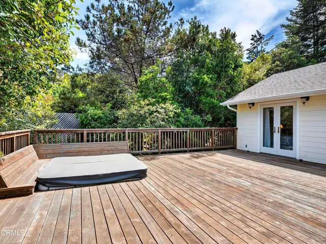a view of balcony with wooden floor and fence