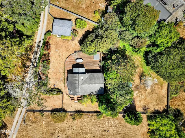 an aerial view of a house with yard and garage