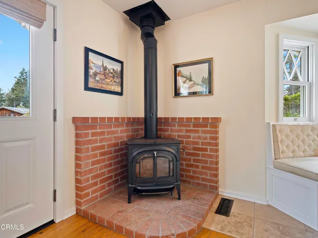 a view of a hallway with furniture and a window