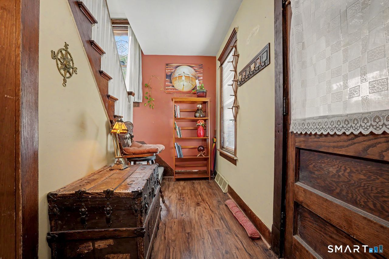 74 Maple Street Seymour, CT 06483 - Photo 5 of 40 a hallway with furniture and wooden floor