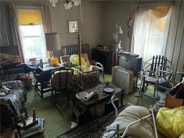 a living room with furniture fireplace and a large window