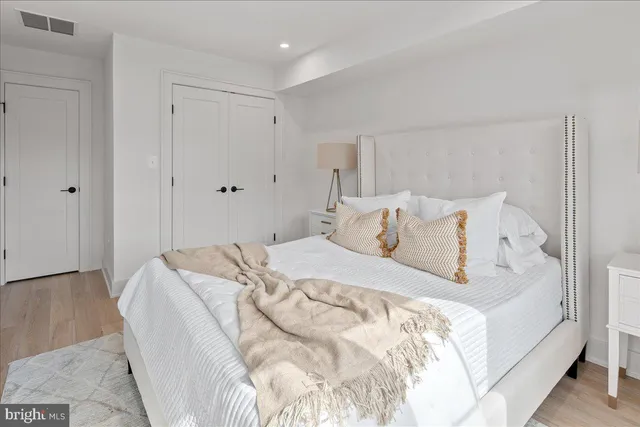 a bedroom with a bed and a dresser