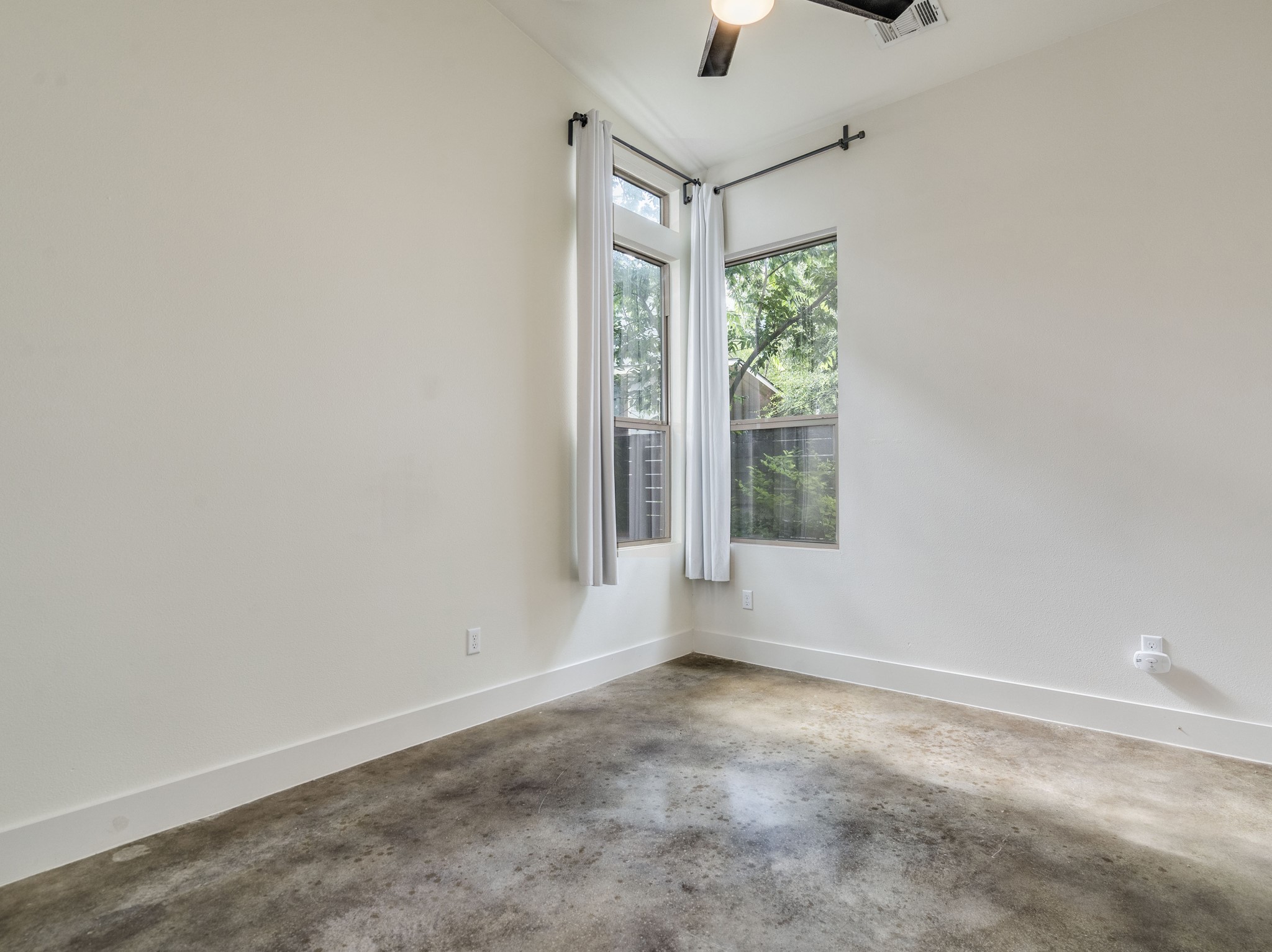 1404 Singleton Avenue, Unit B Austin, TX 78702 - Photo 16 of 21 Concrete floors meet sunlit walls, crafting a minimalist canvas for personalized comfort.