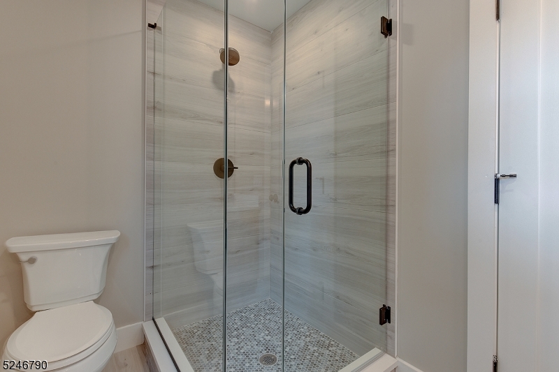 81 Mission Street, Unit 1 Montclair, NJ 07042 - Photo 12 of 19 a white toilet next to a bathroom