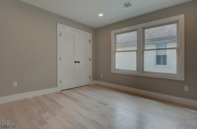 81 Mission Street, Unit 1 Montclair, NJ 07042 - Photo 14 of 19 a view of an empty room with wooden floor and a window