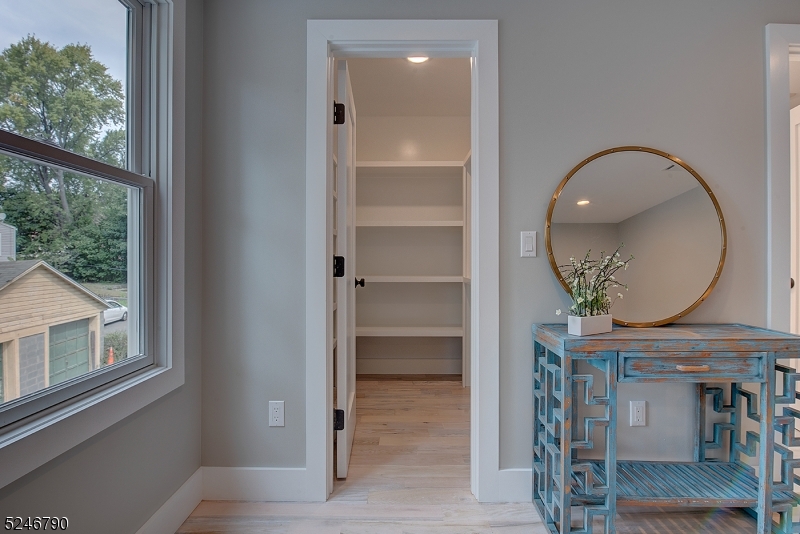 81 Mission Street, Unit 1 Montclair, NJ 07042 - Photo 16 of 19 a room with wooden floor and a mirror