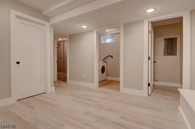 a view of a room with wooden floor and windows