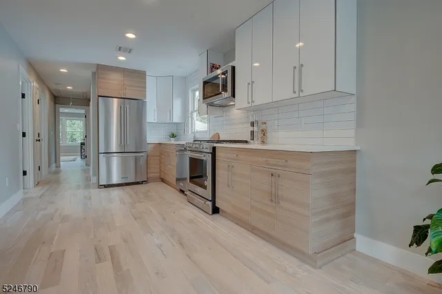 a kitchen with stainless steel appliances granite countertop a refrigerator sink and cabinets
