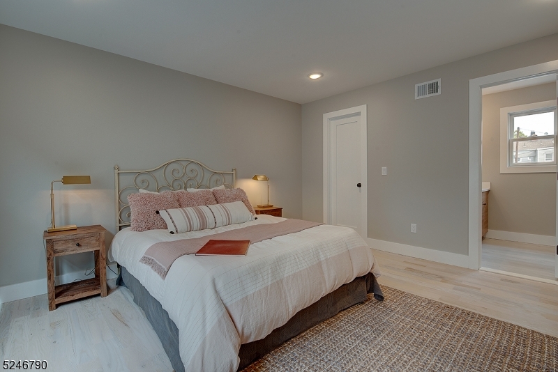 81 Mission Street, Unit 1 Montclair, NJ 07042 - Photo 7 of 19 a bedroom with a bed and a lamp
