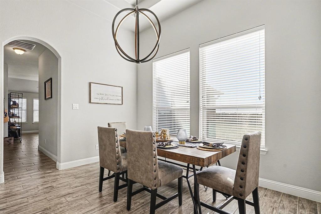 415 Silver Spur Trail Rockwall, TX 75032 - Photo 13 of 40 a view of a dining room with furniture and a window