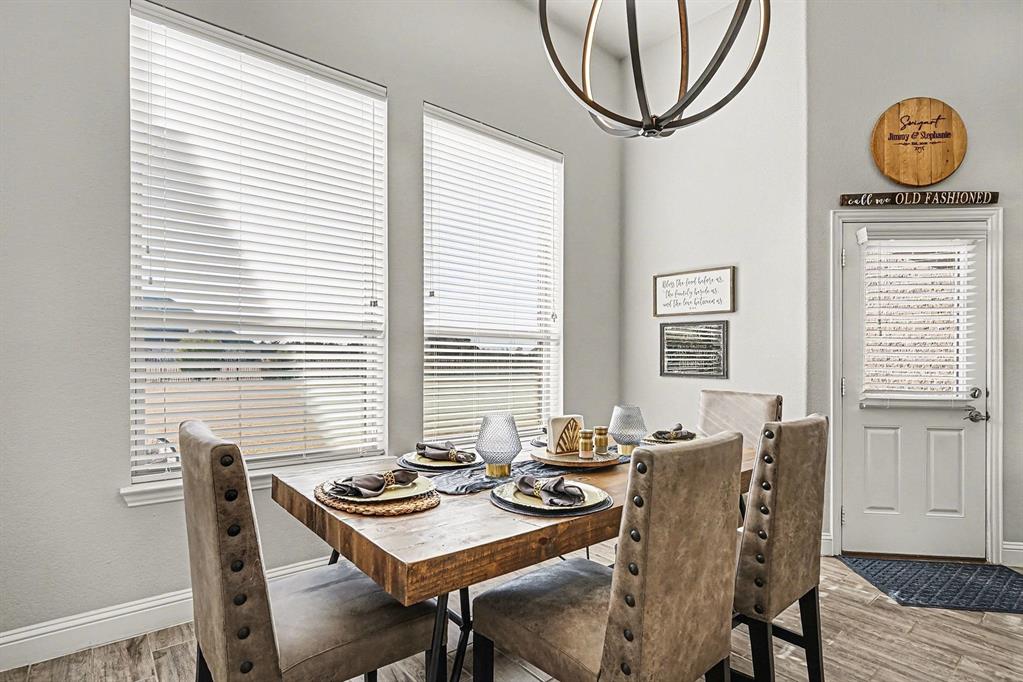 415 Silver Spur Trail Rockwall, TX 75032 - Photo 14 of 40 a view of a dining room with furniture window and wooden floor