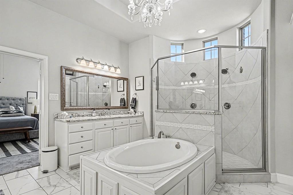 415 Silver Spur Trail Rockwall, TX 75032 - Photo 18 of 40 a bathroom with a granite countertop sink a toilet a mirror and shower