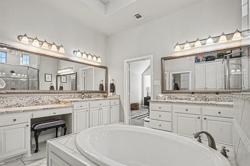 415 Silver Spur Trail Rockwall, TX 75032 - Photo 19 of 40 a spacious bathroom with a granite countertop double vanity sink and a mirror