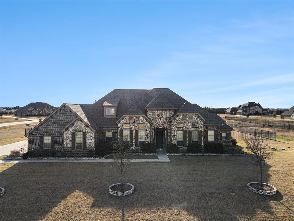 415 Silver Spur Trail Rockwall, TX 75032 - Photo 2 of 40 a front view of a house with a yard