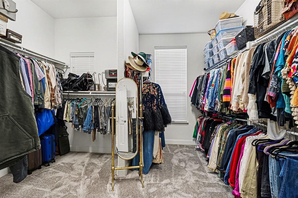 415 Silver Spur Trail Rockwall, TX 75032 - Photo 21 of 40 a view of walk in closet with clothes