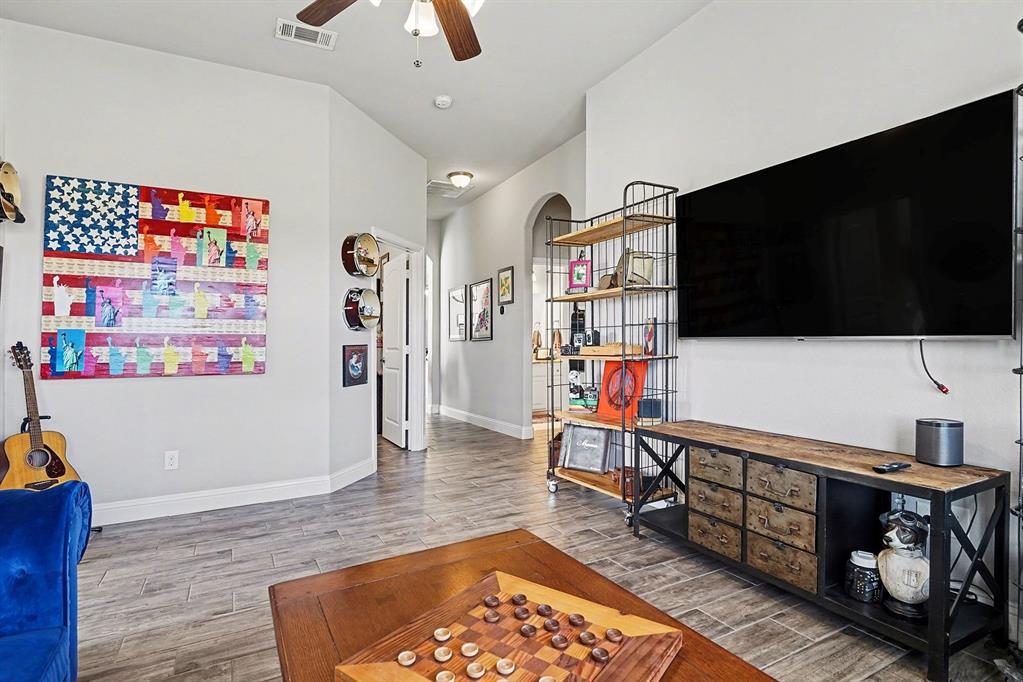 415 Silver Spur Trail Rockwall, TX 75032 - Photo 25 of 40 a living room with furniture and a flat screen tv