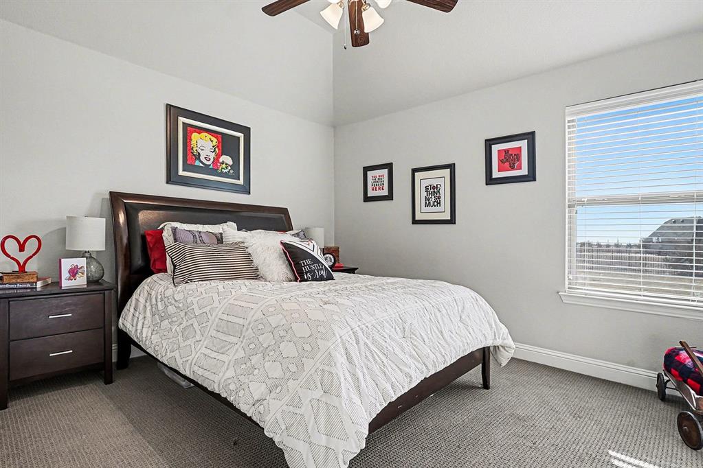 415 Silver Spur Trail Rockwall, TX 75032 - Photo 26 of 40 a bedroom with bed and a window