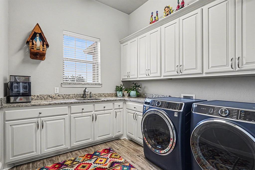 415 Silver Spur Trail Rockwall, TX 75032 - Photo 34 of 40 a utility room with sink dryer and washer