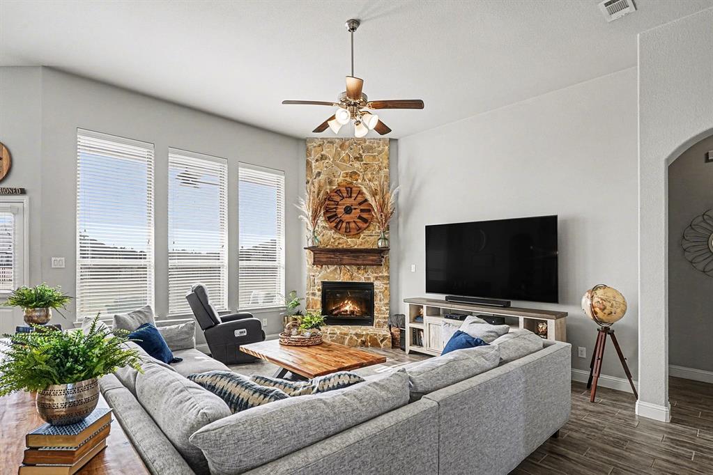 415 Silver Spur Trail Rockwall, TX 75032 - Photo 5 of 40 a living room with furniture a fireplace and a flat screen tv