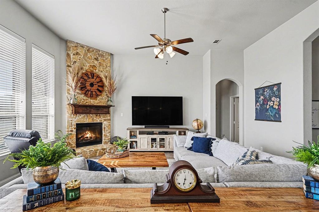 415 Silver Spur Trail Rockwall, TX 75032 - Photo 7 of 40 a living room with furniture a fireplace and a flat screen tv