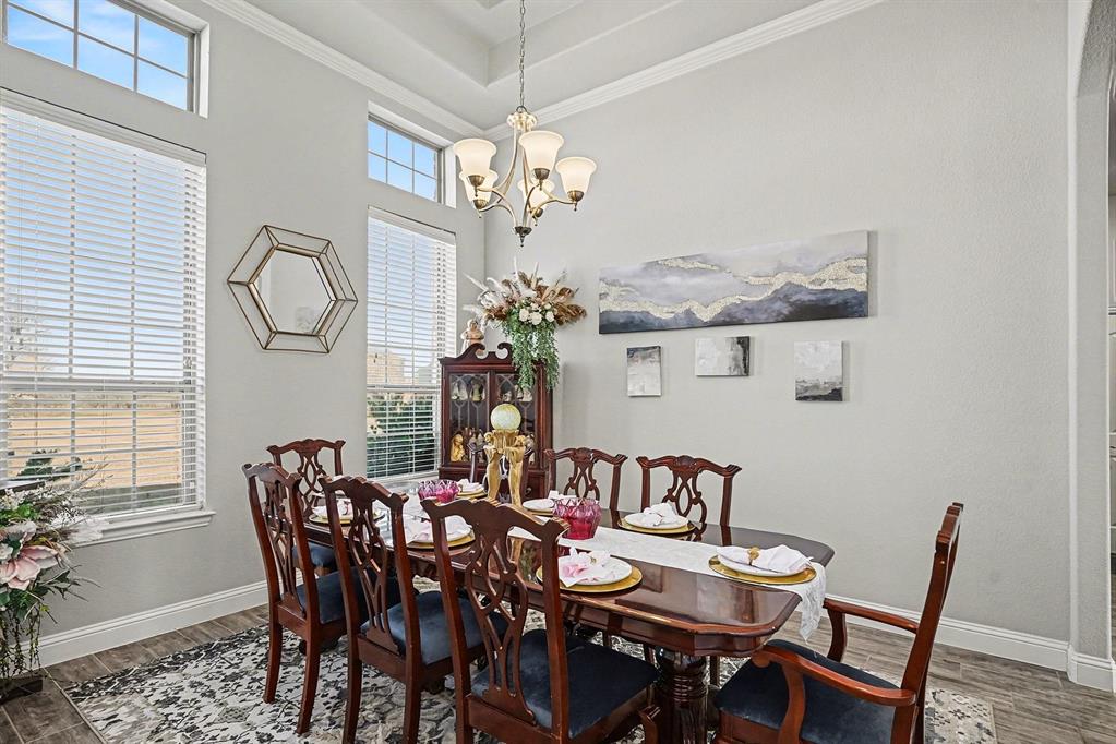 415 Silver Spur Trail Rockwall, TX 75032 - Photo 8 of 40 a view of a dining room with furniture and chandelier