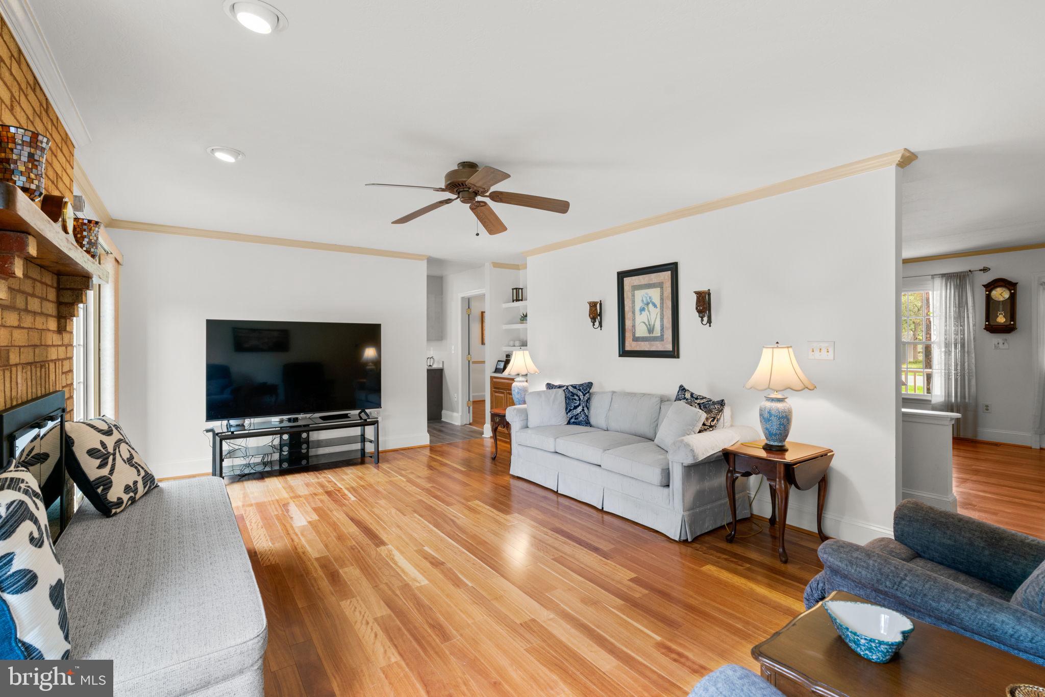 7884 Walnut Grove Road Severn, MD 21144 - Photo 12 of 42 a living room with furniture and a flat screen tv