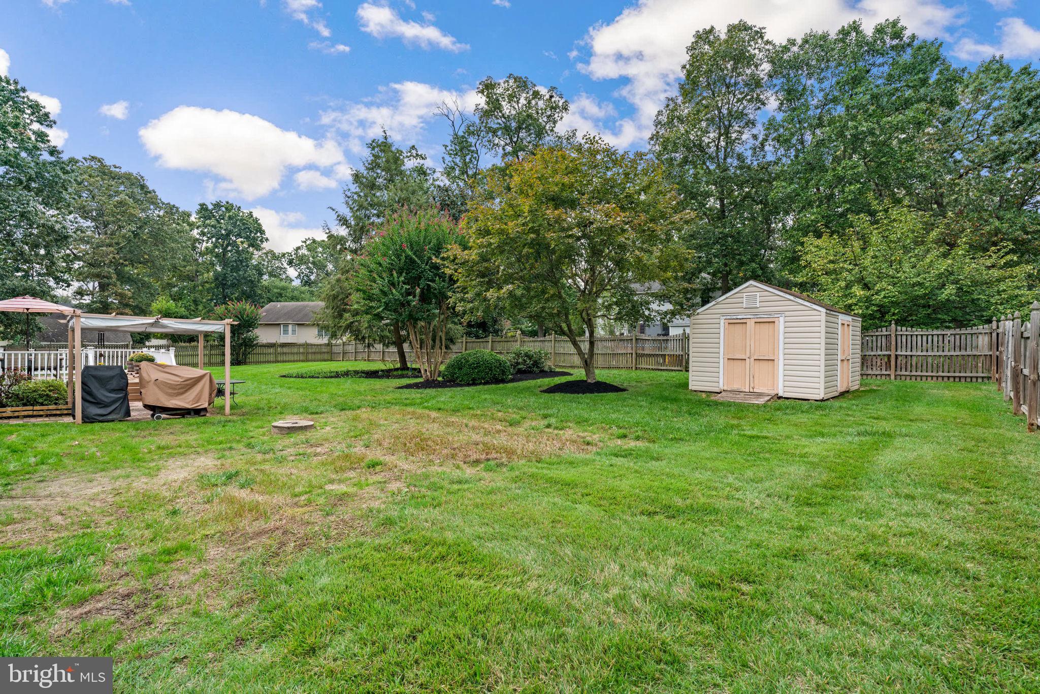 7884 Walnut Grove Road Severn, MD 21144 - Photo 40 of 42 a backyard of a house with table and chairs