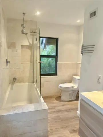 a bathroom with a bathtub and a toilet