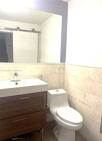 a bathroom with a sink a toilet and mirror