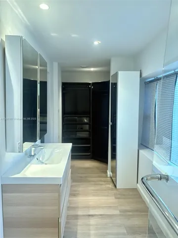a bathroom with a tub shower and sink
