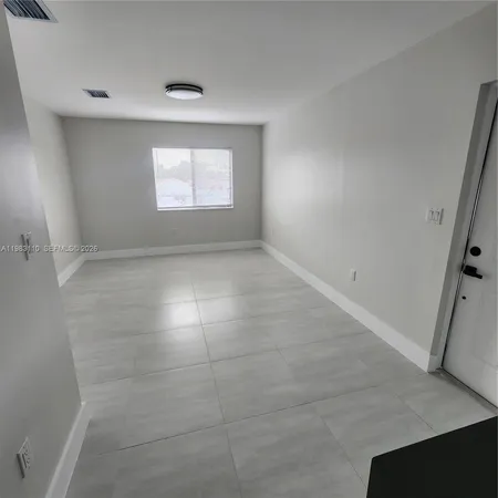a view of kitchen with microwave and cabinets