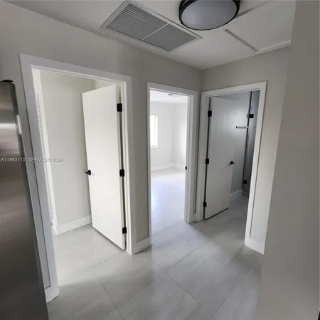wooden view of a hallway with closet and wooden door