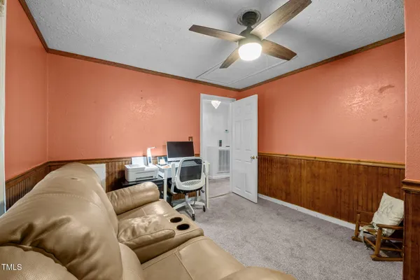 a view of a livingroom with a ceiling fan and a window