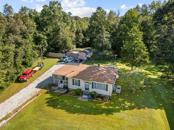 a aerial view of a house with swimming pool and big yard