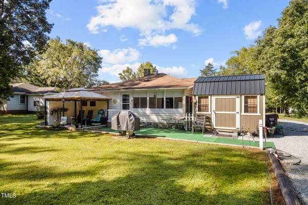 an aerial view of a house with a yard basket ball court and outdoor seating