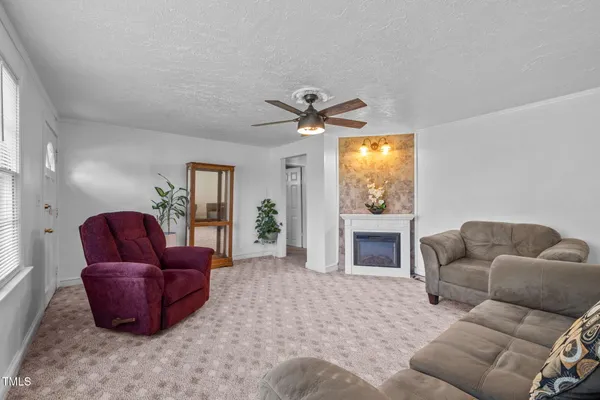 a living room with furniture a window and a fireplace