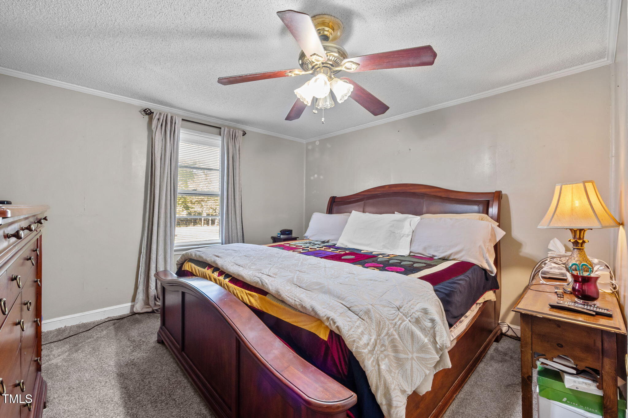 122 Old Surl Road Roxboro, NC 27574 - Photo 8 of 35 a bedroom with a bed and a chandelier