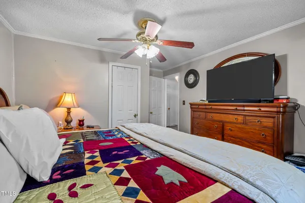 a bedroom with a bed and a chandelier