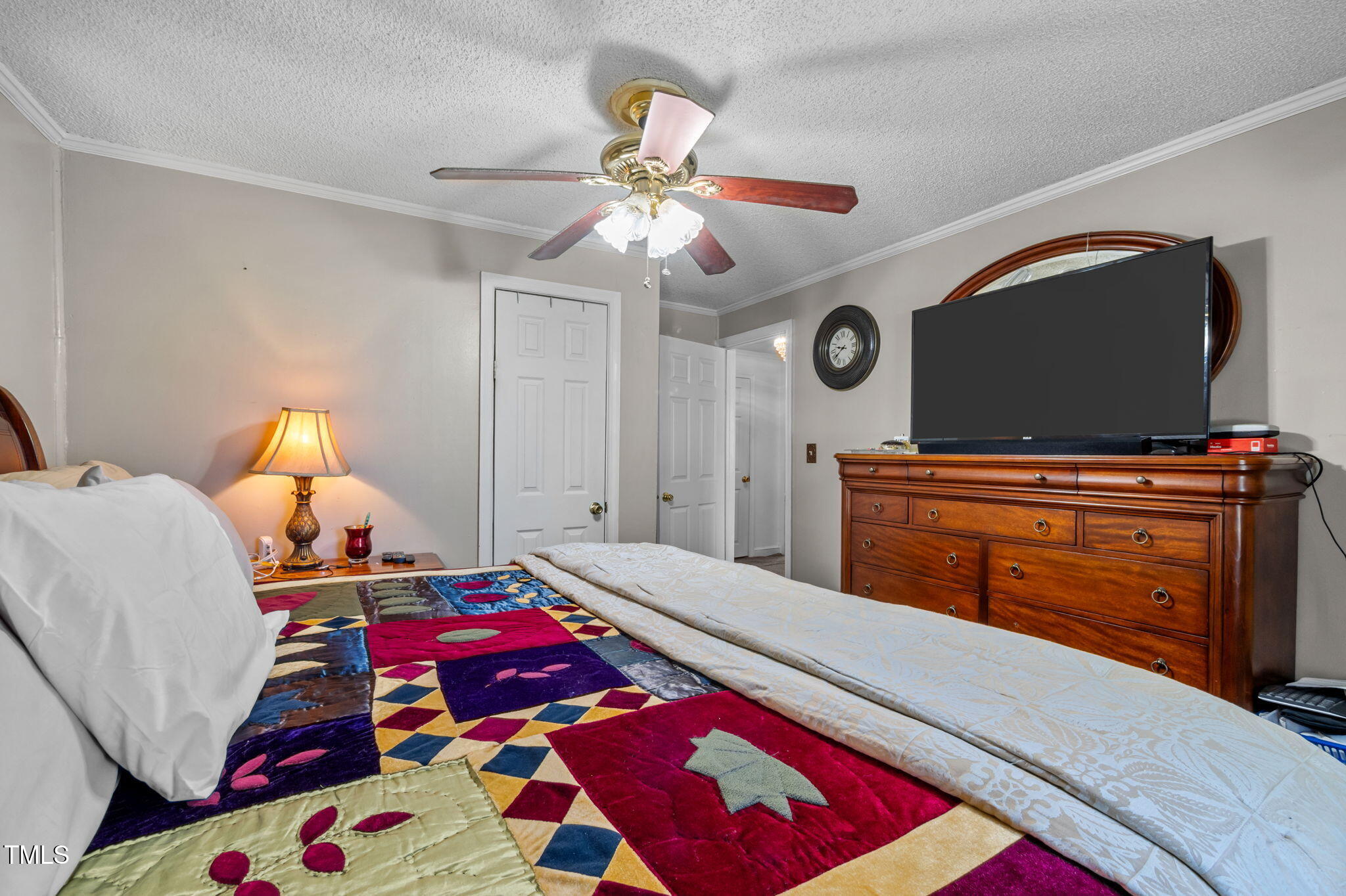 122 Old Surl Road Roxboro, NC 27574 - Photo 9 of 35 a bedroom with a bed and a chandelier